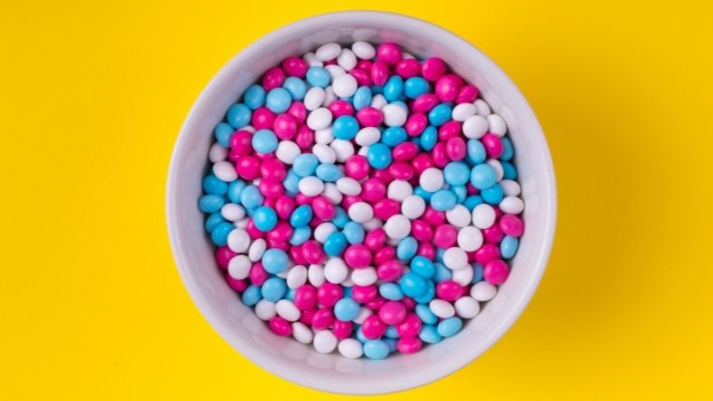 a bowl full of red, blue and white m&ms
